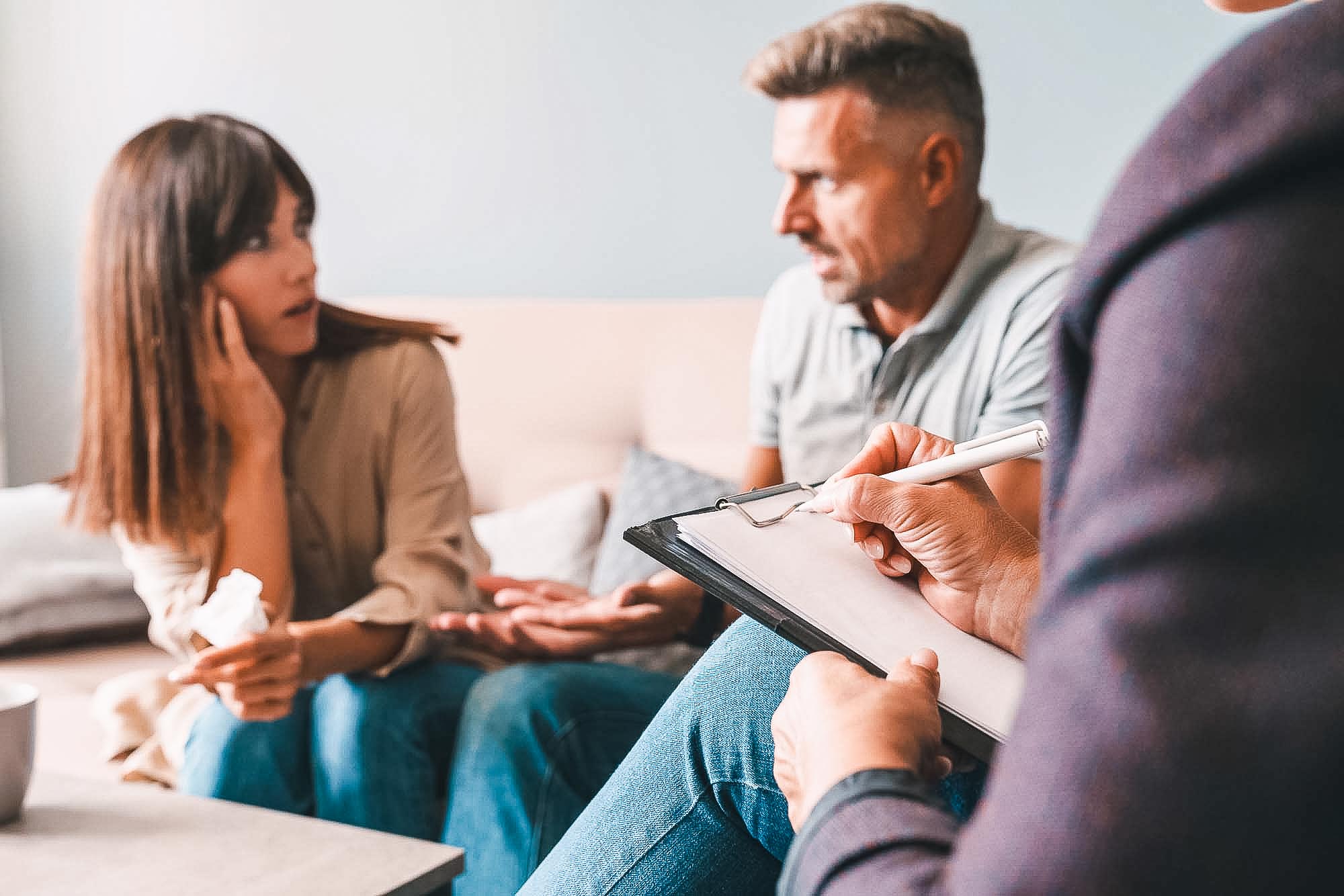 Photo of angry irritated couple having conversation with psychol