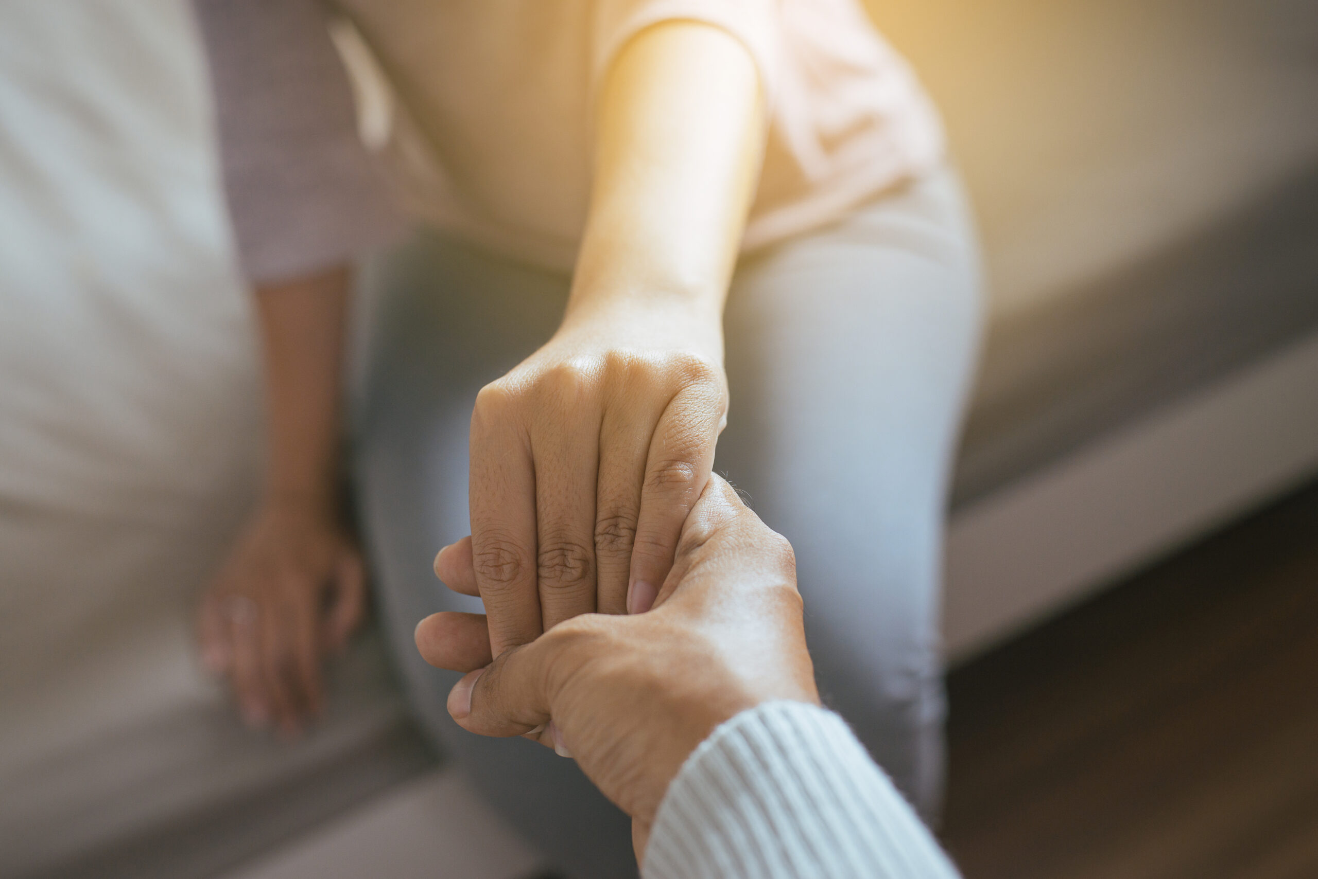 Man giving hand to depressed woman,Psychiatrist holding hands pa